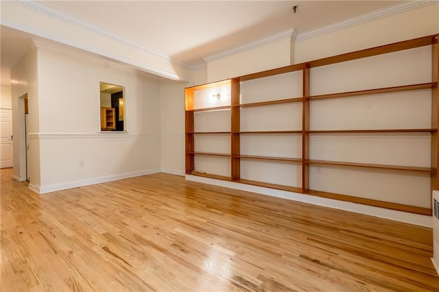 empty room featuring crown molding and light hardwood / wood-style floors