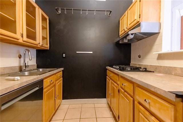 kitchen featuring light tile patterned floors, sink, decorative backsplash, and black appliances