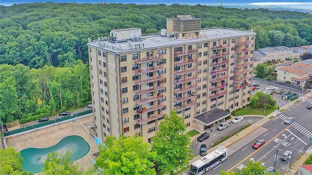 drone / aerial view with a wooded view