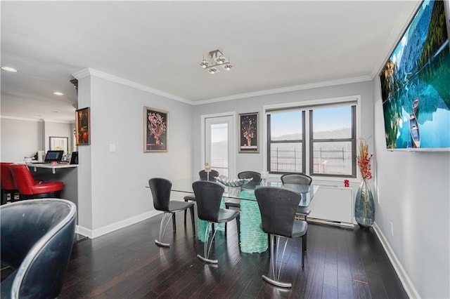 dining area with baseboards, ornamental molding, and wood finished floors