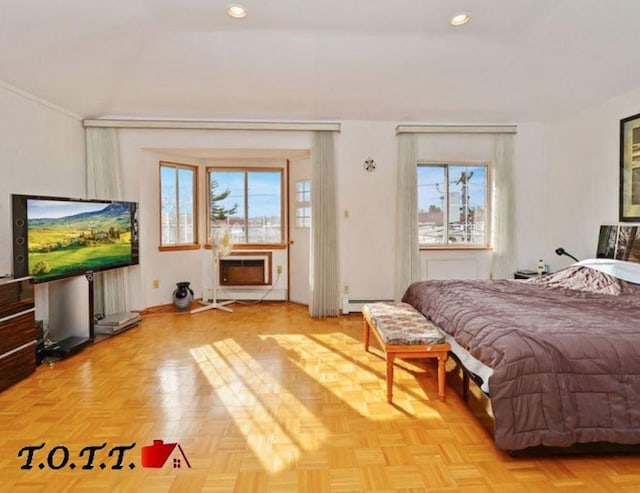 bedroom with a baseboard heating unit and light parquet floors