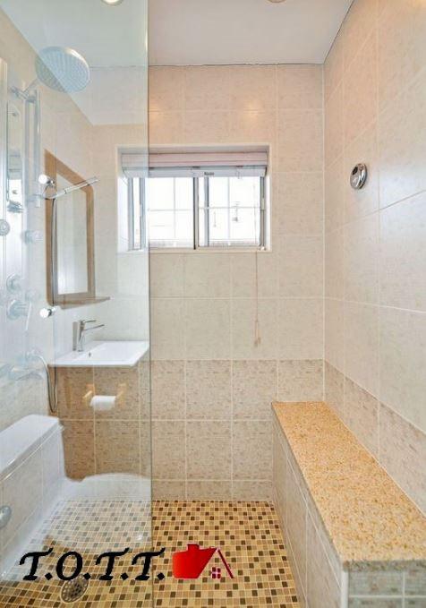 bathroom with tiled shower and sink