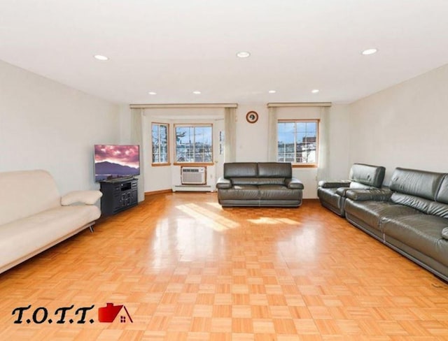 unfurnished living room featuring light parquet flooring and an AC wall unit