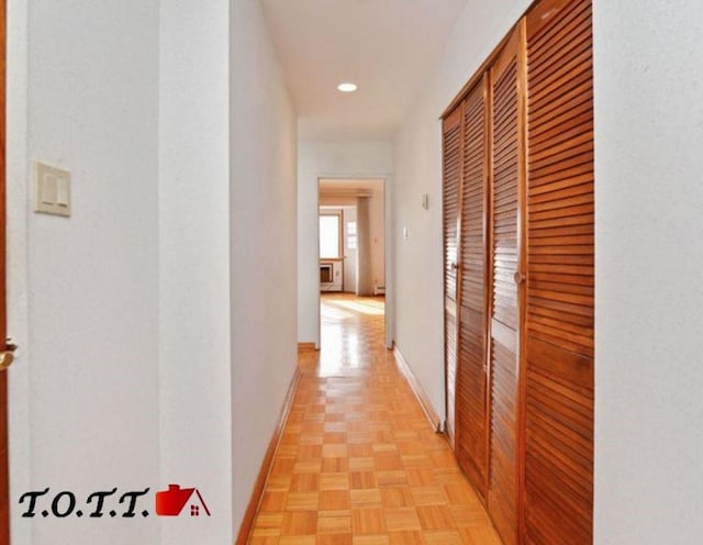 hallway featuring light parquet flooring