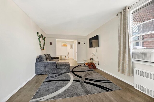 living room with radiator heating unit and dark hardwood / wood-style floors