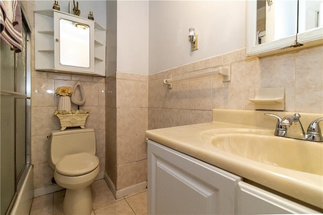 full bathroom with toilet, enclosed tub / shower combo, tile walls, tile patterned flooring, and vanity