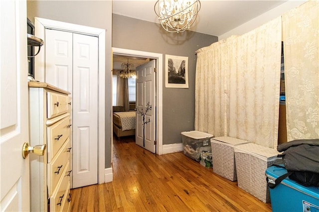 591 Van Siclen Ave, Brooklyn, NY 11207 - corridor featuring baseboards, wood finished floors, and a chandelier