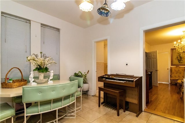 dining room featuring an inviting chandelier and light tile patterned floors