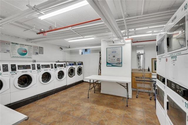 laundry room with washing machine and dryer and stacked washer / dryer