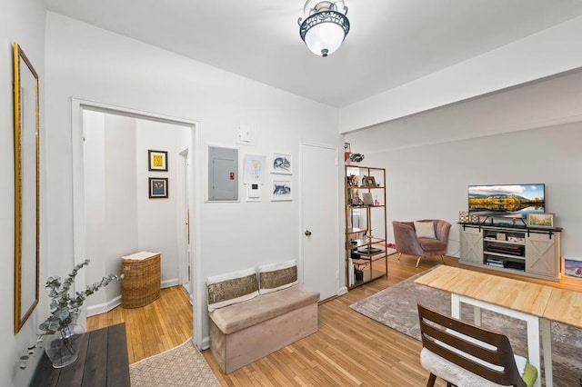 office area with electric panel and light wood-style floors