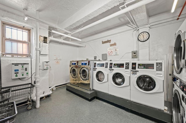 shared laundry area featuring stacked washer / drying machine, a textured ceiling, and tile patterned floors