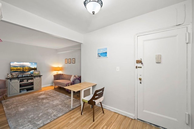 entrance foyer featuring light wood-style flooring and baseboards