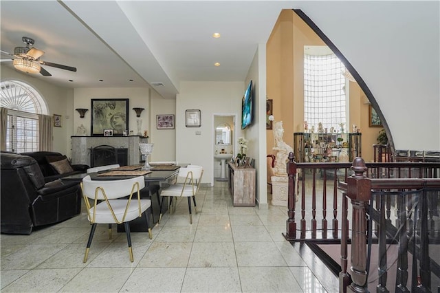 living room featuring tile patterned flooring, a fireplace, ceiling fan, and recessed lighting