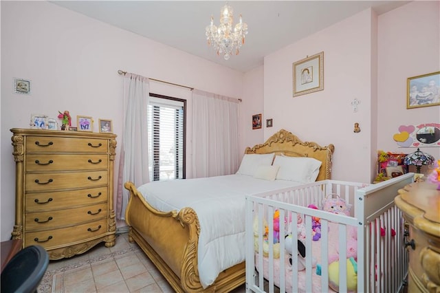 bedroom with light tile patterned floors and a chandelier