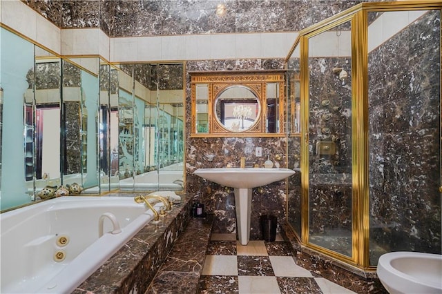 bathroom with a tub with jets, marble finish floor, and a stall shower