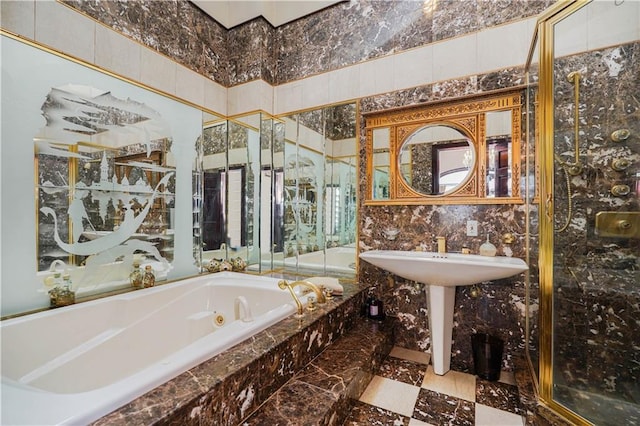 bathroom featuring tile walls and a tub with jets