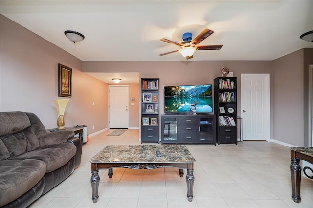 living room with a ceiling fan, baseboards, and light tile patterned floors