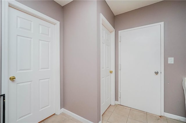 interior space featuring light tile patterned floors and baseboards