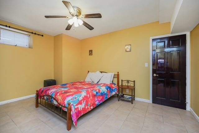 bedroom with baseboards, ceiling fan, and light tile patterned floors