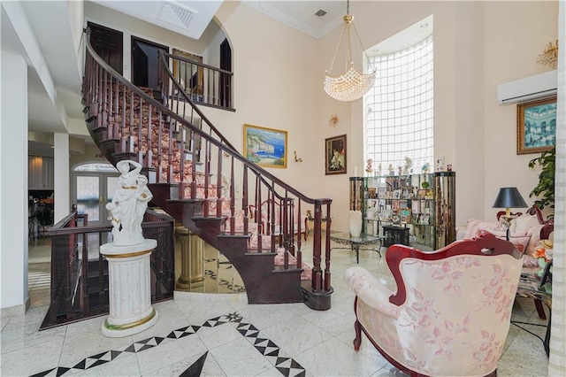 foyer entrance with a wall unit AC, crown molding, a towering ceiling, and stairs