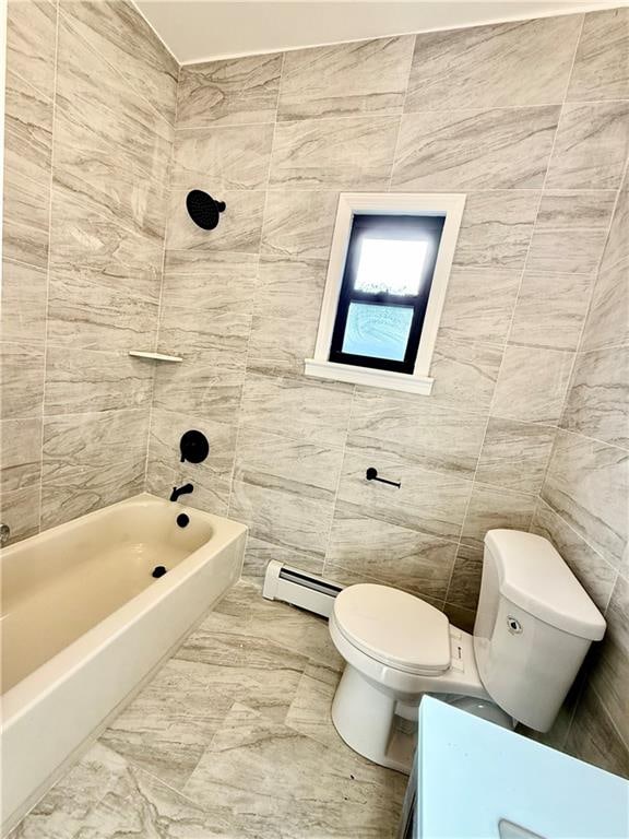 bathroom featuring toilet, tiled shower / bath combo, tile walls, and a baseboard heating unit