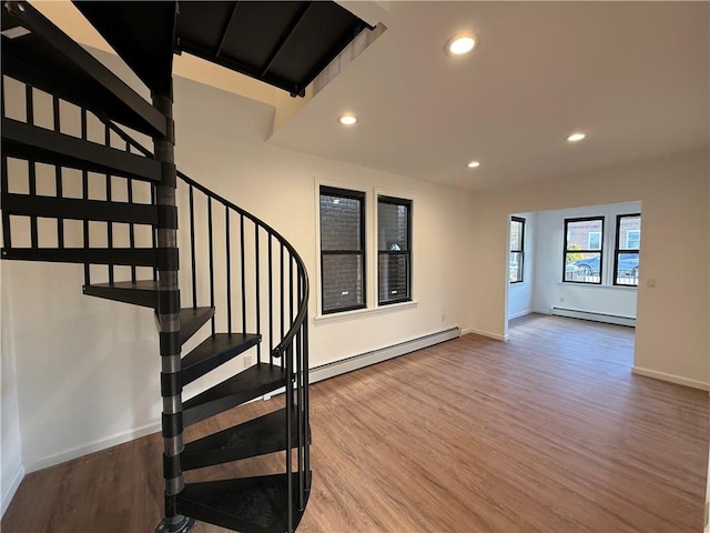 interior space featuring hardwood / wood-style flooring and a baseboard heating unit