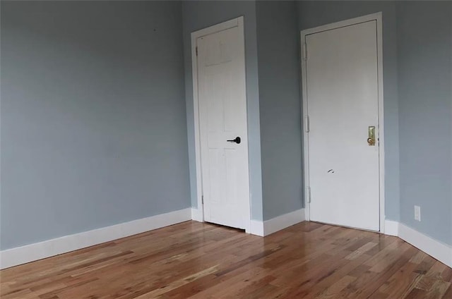 unfurnished bedroom with hardwood / wood-style flooring