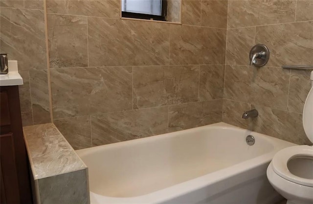 full bathroom featuring vanity, toilet, and tiled shower / bath combo