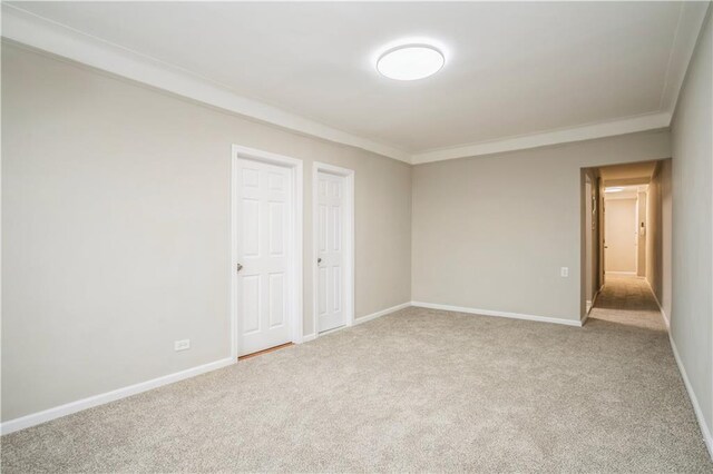 carpeted spare room with crown molding