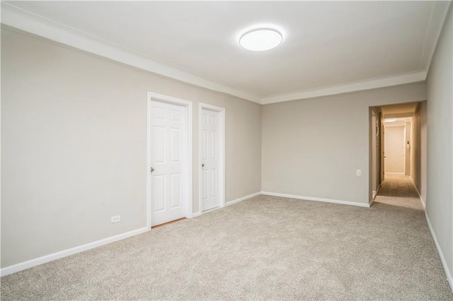 unfurnished room with carpet, baseboards, and ornamental molding