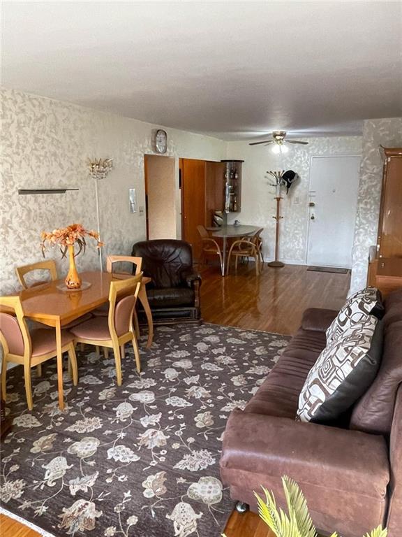 living room with hardwood / wood-style flooring and ceiling fan