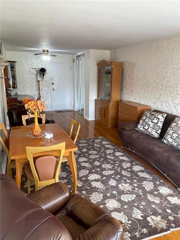 living room featuring hardwood / wood-style floors and ceiling fan