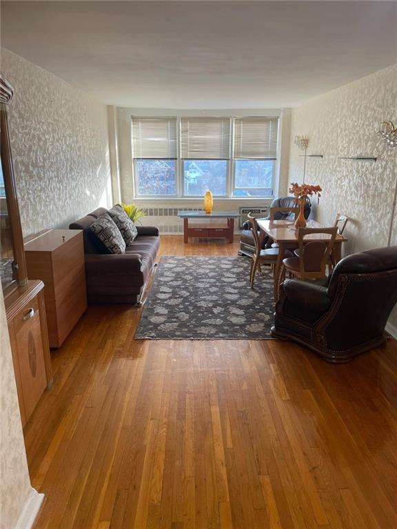 living room featuring radiator and wood-type flooring