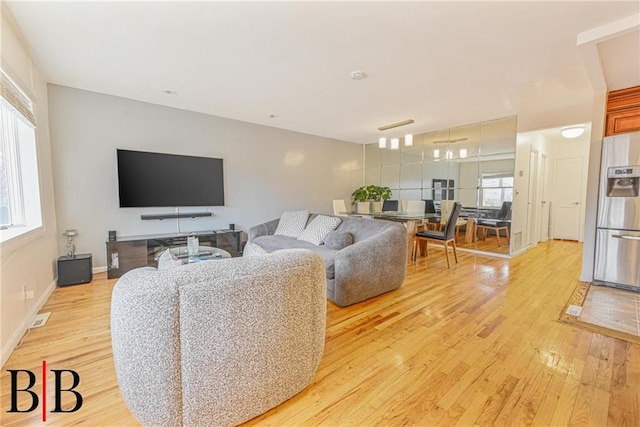 living room featuring a wealth of natural light and light wood-type flooring