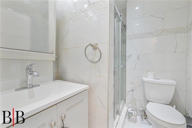 bathroom featuring toilet, vanity, tile walls, and walk in shower