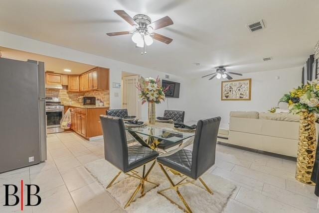 dining room featuring ceiling fan and light tile patterned flooring