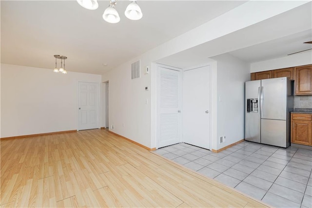 interior space featuring light wood-type flooring and a chandelier