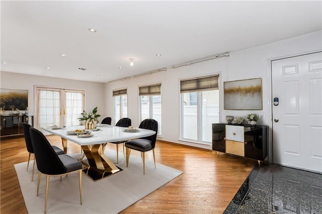 dining space with light wood-style floors, recessed lighting, french doors, and visible vents