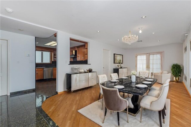 dining space featuring an inviting chandelier and french doors