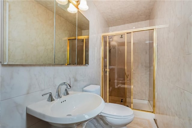 bathroom featuring sink, tile walls, an enclosed shower, and toilet