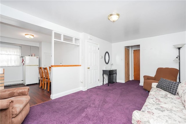 living room featuring a baseboard radiator and dark colored carpet