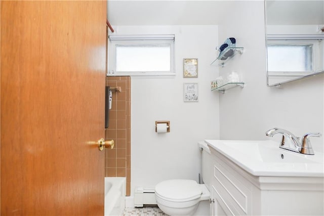 full bathroom with vanity, a baseboard heating unit, tiled shower / bath combo, and toilet