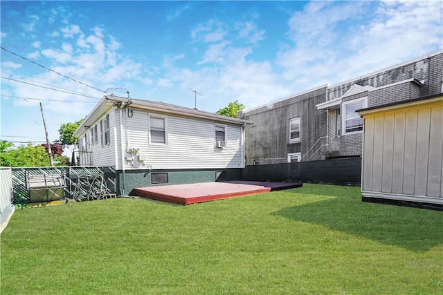 back of house with a yard and a deck