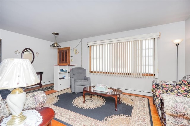 living room with light hardwood / wood-style floors and baseboard heating