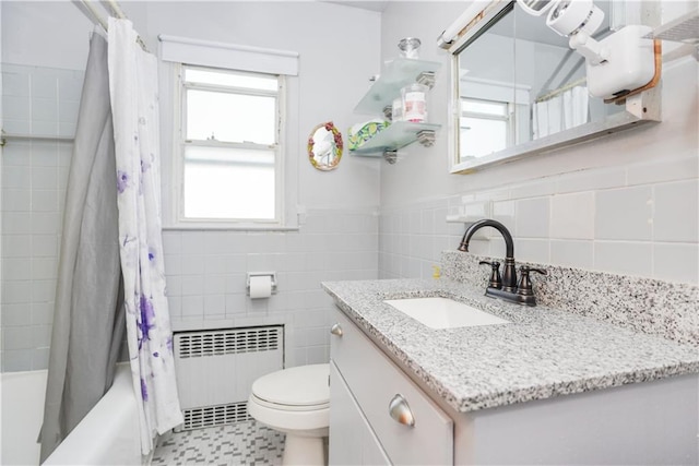 full bathroom with tile walls, radiator, a wealth of natural light, and toilet