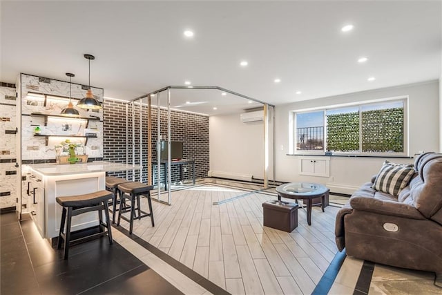 living area featuring recessed lighting, baseboards, a wall mounted AC, and wood finished floors