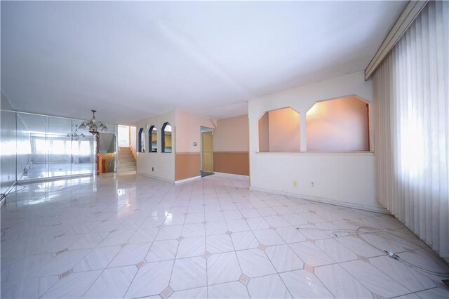 empty room with a notable chandelier