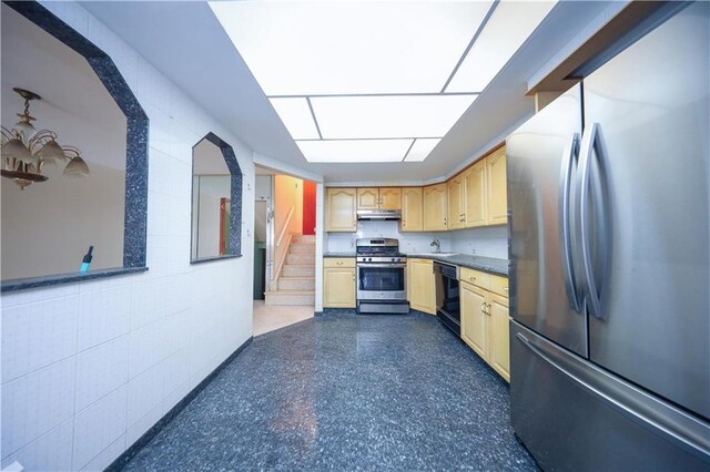 kitchen featuring appliances with stainless steel finishes, light brown cabinetry, and sink