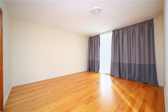 empty room with hardwood / wood-style floors