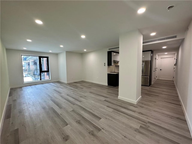 unfurnished living room with light hardwood / wood-style flooring